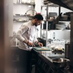 man in white dress shirt holding white ceramic plate